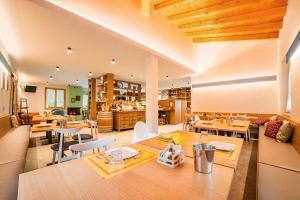 a kitchen and dining room with tables and chairs at La Fontanina in Vobarno