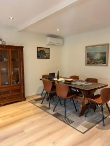 a dining room with a table and chairs at Huset ved fergekaien på Moskenes in Moskenes