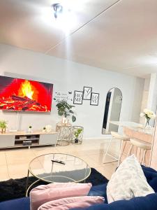 a living room with a fire on the wall at Fully Furnished 3 bedroom apartment rental in Roodepoort