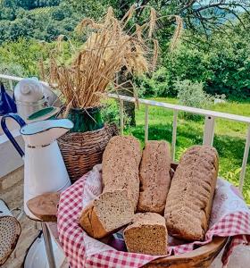 a basket of bread on a table with a basket of hay at Ai due Gelsi in Grancona +45 photos
