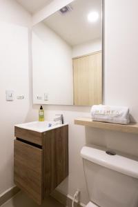 a bathroom with a sink and a toilet and a mirror at Mishka Hotel Boutique Habitación 103 in Cartagena de Indias