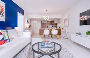 a living room with a white couch and a table at MVR - High-End Condo with Miami Views in Miami +24 photos