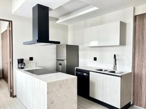 a kitchen with a sink and a refrigerator at Tizate Residents 202 in Cruz de Huanacaxtle