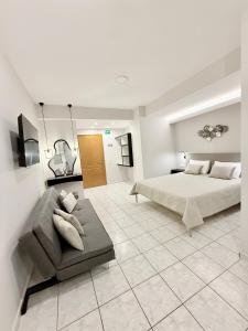a large bedroom with a bed and a couch at Avenue Hotel Falassarna in Falasarna