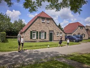 a group of people standing in front of a house at Farmhouse in Limburg near Subtropical Pool in Roggel