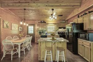 a kitchen with a table and chairs and a kitchen with wooden walls at Bear Retreat in Sevierville