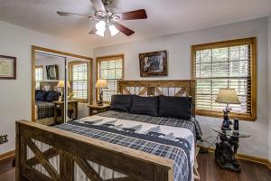 a bedroom with a bed and a ceiling fan at Bear Retreat in Sevierville