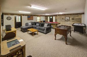 a living room with couches and a pool table at Bear Retreat in Sevierville