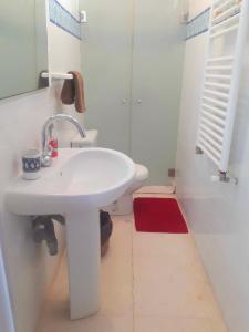 a white bathroom with a sink and a toilet at Sidi Bou House in Sidi Bou Saïd