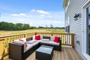 a patio with a couch and a table on a deck at Lunar Haven - Gorgeous 5 BDR in Walton