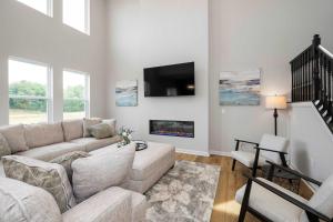 a living room with a couch and a tv at Lunar Haven - Gorgeous 5 BDR in Walton