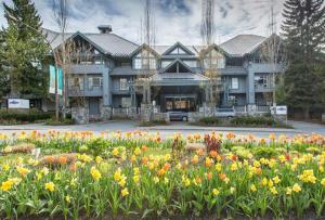 a large building with flowers in front of it at Glacier Lodge 216 by Outpost Whistler in Whistler