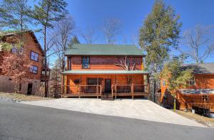a large wooden house with a large garage at Pebblestone Lodge in Pigeon Forge