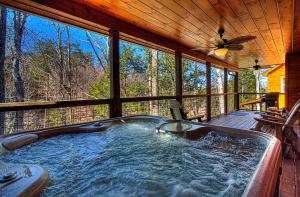 a jacuzzi tub in the middle of a house at Pebblestone Lodge in Pigeon Forge