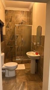 a bathroom with a toilet and a sink and a shower at The86thGuest Krugersdorp in Krugersdorp