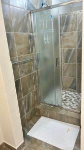 a shower with a glass door in a bathroom at The86thGuest Krugersdorp in Krugersdorp +56 photos