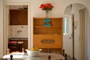 a kitchen with a table with a bowl of fruit on it at Casa Olimpia in Forio d'Ischia