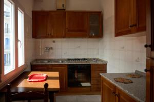 a kitchen with wooden cabinets and a red bowl on a table at Casa Olimpia in Forio d'Ischia