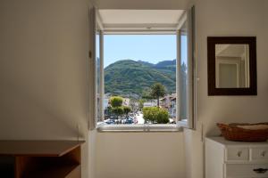 a window in a room with a view of a city at Casa Olimpia in Forio d'Ischia