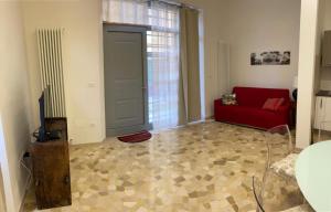 a living room with a red couch and a window at Casa Ninni in Fano