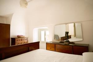 a bedroom with a bed and a large mirror at Casa Olimpia in Forio d'Ischia +8 photos