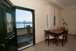 a dining room with a table and a view of the ocean at Hercules in Amaliapoli