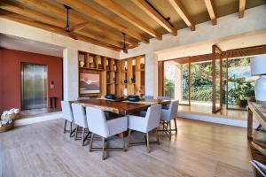 a dining room with a wooden table and chairs at Casa Sirenas - Paradise in Puerto Vallarta in Cruz de Huanacaxtle