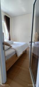 Postel nebo postele na pokoji v ubytování Pucuk Dieng Syariah Inn + 3 fotografie