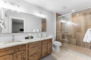 a bathroom with a sink and a toilet and a shower at Pineview on Baycolt- remodeled w/great parking, near downtown and golf course in McCall +44 photos