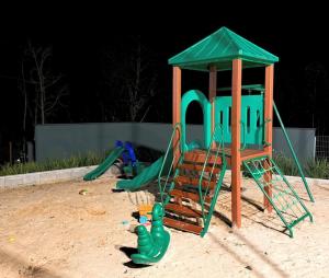 a playground with a play set in the sand at Acampamento Pinhais in Rodeio