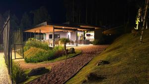 a house on a hill at night at Acampamento Pinhais in Rodeio