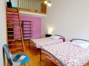 a bedroom with a bunk bed and a ladder at Chambres "Chez ELLE" in Oraison