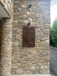 a sign on the side of a stone wall at Briançon au pied des pistes in Briançon +5 photos