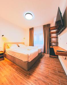 a hotel room with a bed and a television at MAKIS Luxury Apartments City Center Free Parking in Ohrid