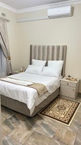 a bedroom with a bed with a silver headboard at The86thGuest Krugersdorp in Krugersdorp
