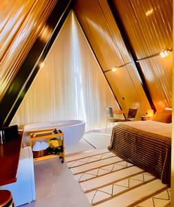 un bagno con un letto e una vasca in una stanza di Chalé África - Sauípe Breezes - Linha Verde a Camboguê