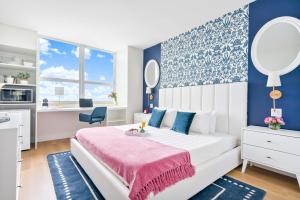a bedroom with a white bed with a pink blanket at MVR - Your Private Slice of Grove Luxury Awaits in Miami