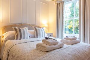 a bedroom with a bed with towels on it at The Railway Cottage in Rothley