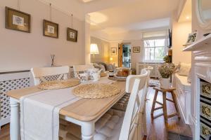 a dining room with a table and a fireplace at The Railway Cottage in Rothley