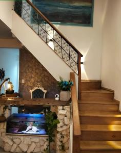 a staircase with a stone fireplace in a house at Hotel Boutique Tierra Del Mar Cartagena in Cartagena de Indias
