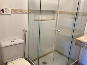a bathroom with a toilet and a glass shower at Beach Front 2 Bed Rooms - Balcony with Full Sea View - Praia do Pepê in Rio de Janeiro +19 photos