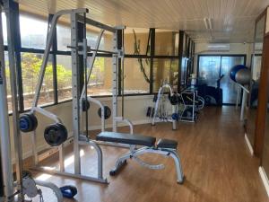 a gym with treadmills and weights in a room at Beach Front 2 Bed Rooms - Balcony with Full Sea View - Praia do Pepê in Rio de Janeiro