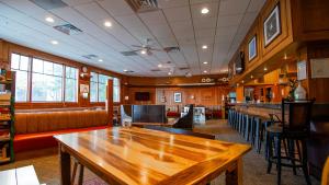 a bar with a wooden table in a restaurant at Park City Hostel in Park City