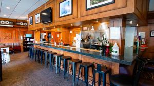 a bar with a row of stools in a restaurant at Park City Hostel in Park City