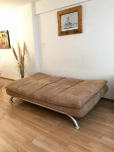 a large bed sitting in a room with a wall at Loft plaza España in Mendoza