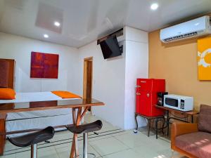 a small room with a bed and a table and chairs at Suite 607 Ciudad jardín San Miguel A in San Miguel