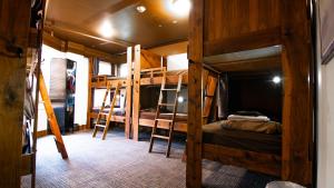 a room with three bunk beds and a hallway at Park City Hostel in Park City