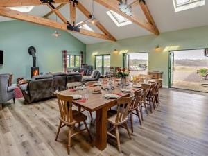 a large dining room with a long table and chairs at 6 Bed in Oakford 60494 in North Molton