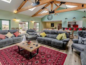 a large living room with couches and a table at 6 Bed in Oakford 60494 in North Molton