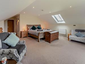 a large bedroom with a bed and a couch at 6 Bed in Oakford 60494 in North Molton +27 photos